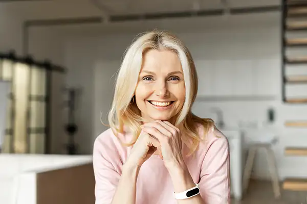 Smiling woman sitting in room with teeth whitening treatment from Riverwind Dental in Richmond, VA
