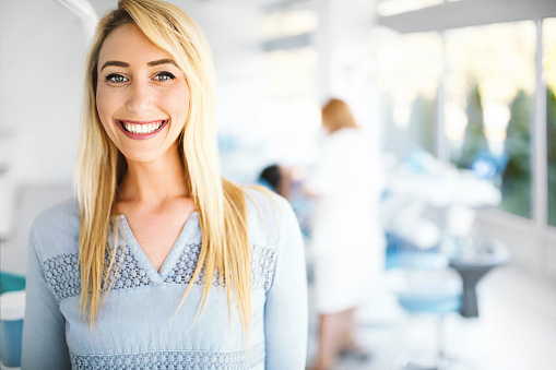 Woman smiling after dental cleaning done at  Dental implants being placed at Riverwind Dental in Richmond, VA 