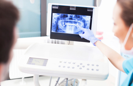 Dentist explaining digital x-ray picture to patient at Riverwind Dental in Richmond, VA