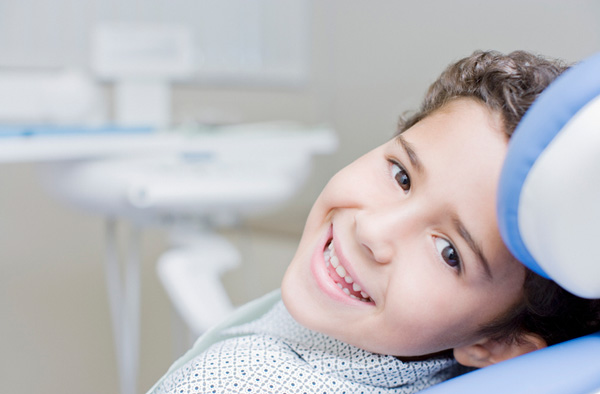 Young boy at Riverwind Dental in Richmond, VA smiling with healthy teeth