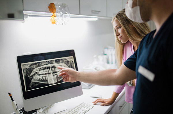 A dentist reviewing a digital xray at Riverwind Dental in Richmond, VA A dentist reviewing a digital xray at Riverwind Dental in Richmond, VA