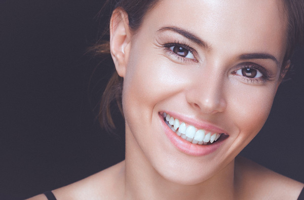 Woman smiling with perfect teeth thanks to Riverwind Dental in Richmond, VA