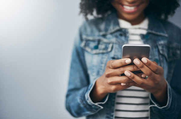 Woman looking at website on her phone at Riverwind Dental in Richmond, VA