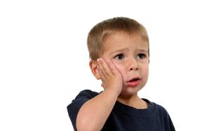 Little boy hand on face with a toothache