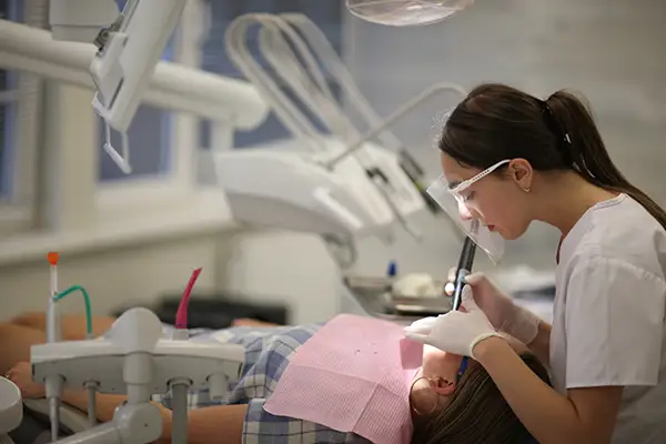 Dentist performing a restorative dental procedure on a patient at Riverwind Dental in Henrico, VA