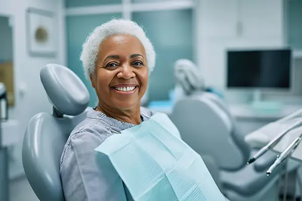 A smiling senior woman in dental chair ready and waiting for her dental procedure at Riverwind Dental in Henrico, VA