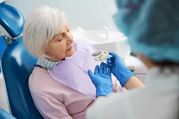 Dentist taking a silicone dental impression of a senior woman's teeth at Riverwind Dental in Henrico, VA