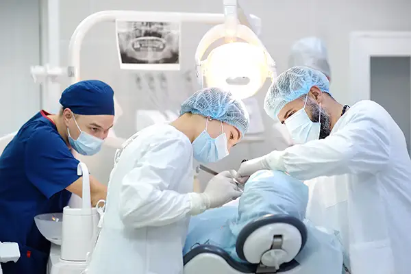 A team of dentists and oral surgeons performing wisdom teeth removal on a patient at Riverwind Dental in Henrico, VA